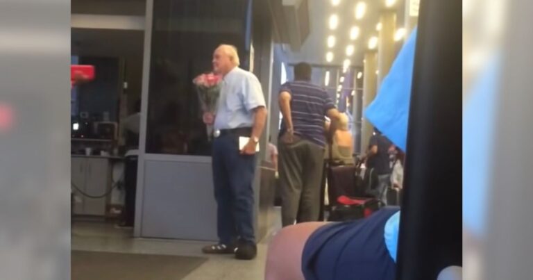 Elderly man secretly filmed waiting for his wife at airport with chocolate and flowers