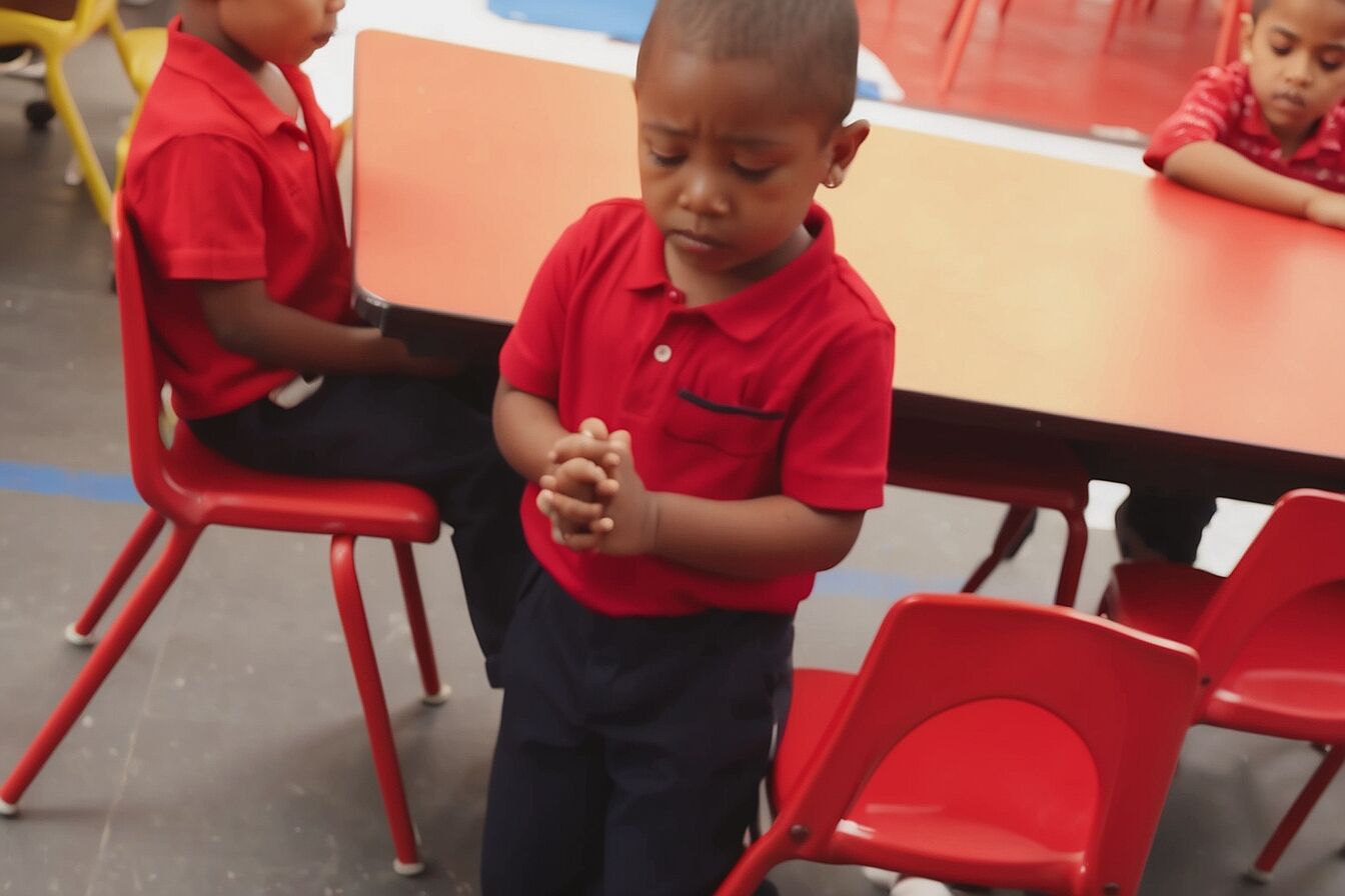 The little boy prays every day before eating